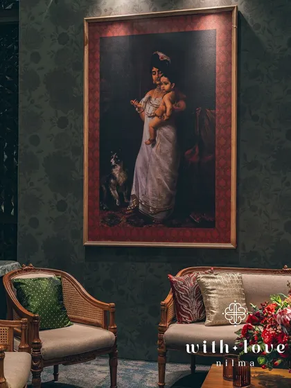 Another beautiful seating arrangement, where a Raja Ravi Varma painting of Yashoda and Krishna adds a touch of divine love and maternal warmth to the decor.