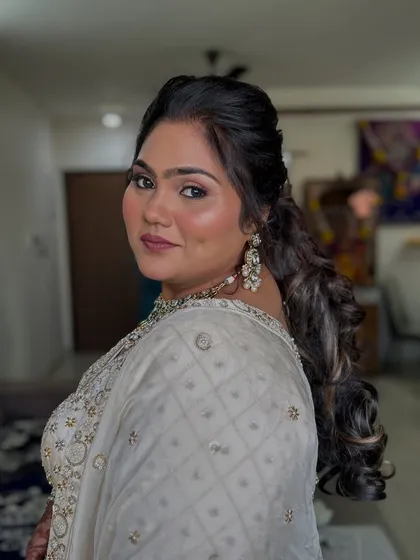 This angle shows the elegant hairstyle and how it complements the overall look.