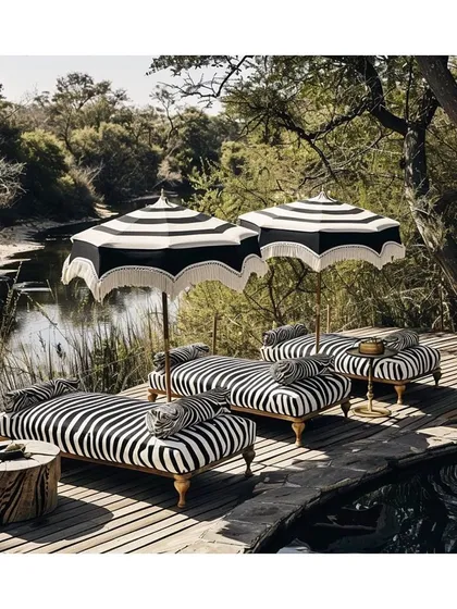 Luxury living extends beyond the interiors. I source and apply high-performance outdoor fabrics, like this classic black and white stripe, to create chic, durable, and weather-resistant sanctuaries for you to lounge and relax in style.
