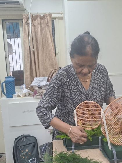 A participant in our Diwali workshop carefully works on her design. Our workshops are open to everyone, regardless of age or experience, offering a chance to learn a new skill in a friendly setting.