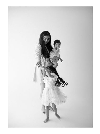 A mother's gentle gaze as her children play around her. These are the timeless memories of motherhood I strive to capture, full of grace and love.