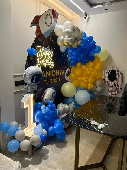 An angled view of the home-based space theme setup, showing the light-up number '1' and astronaut cutouts.