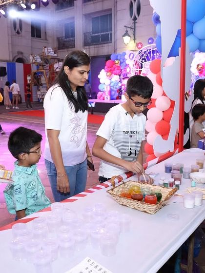 A slime-making station at a carnival. This is a great example of combining a creative activity with a carnival stall setup for double the fun.