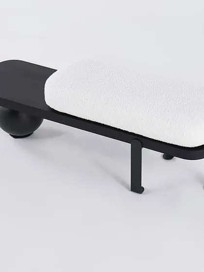 A studio shot of the white Bouclé bench, showcasing its unique and artistic composition.