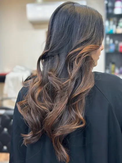 The right hair color can change everything. This rich brown with soft curls is a perfect example.