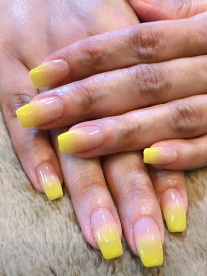 A bright and cheerful yellow ombre. These nails fade from a sheer nude base to a sunny yellow tip, perfect for adding a pop of color to your look.