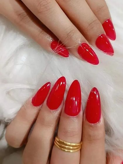 A set of perfectly shaped, glossy red almond nails. A classic look that never goes out of style.