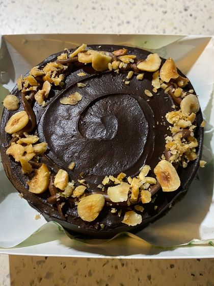 This is my Nutella hazelnut bento cake, a mini cake perfect for small, intimate celebrations. It's a rich chocolate cake with a swirl of Nutella frosting, generously topped with crunchy roasted hazelnuts.