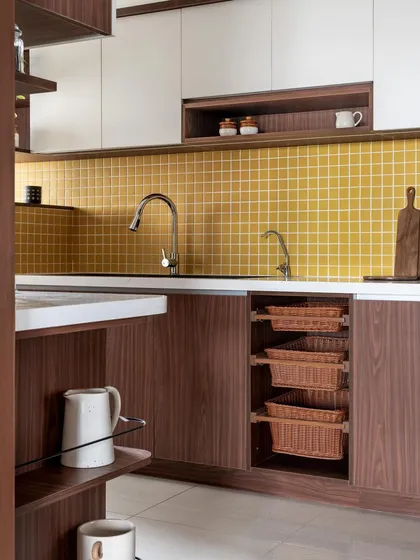 Another angle of the 'Living Life in Colour' kitchen, highlighting the pull-out wicker baskets and the seamless integration of the sink and countertop.