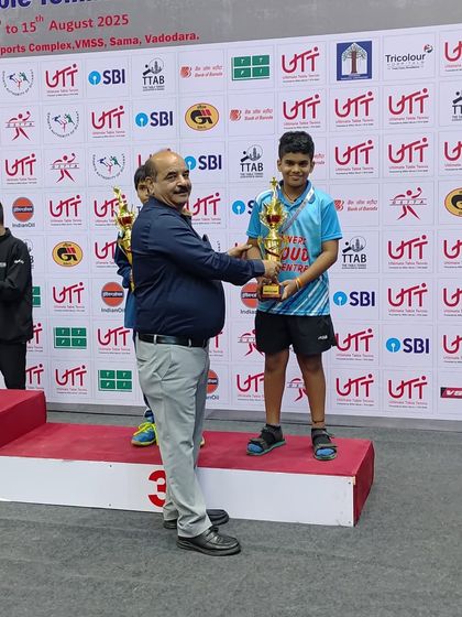 Sharvil K on the podium receiving his trophy for the bronze medal win at the 1st National Ranking TT tournament in the U11 Boys category.