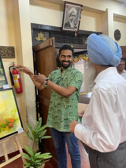 Explaining my artwork to Dr. Chiranjiv Singh at the Vasanthotsava cultural festival inauguration.