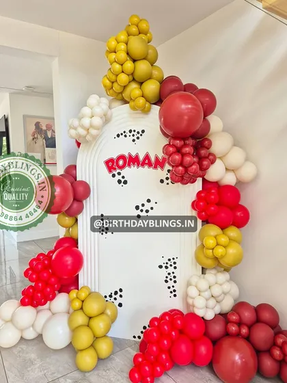 A custom-themed party with a Dalmatian-spot backdrop and a balloon arch in red, yellow, and white.