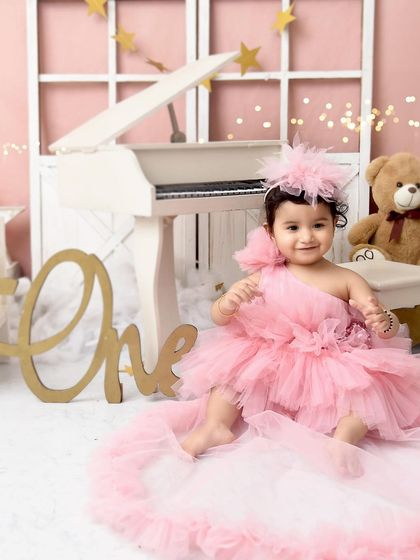 Another lovely shot of our little pink princess. The soft lighting and dreamy props make this a perfect image for a first birthday announcement.