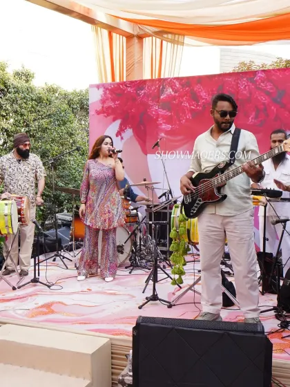 A live fusion band performing at a daytime celebration. The combination of traditional and modern instruments created a unique and engaging musical experience for all the guests.