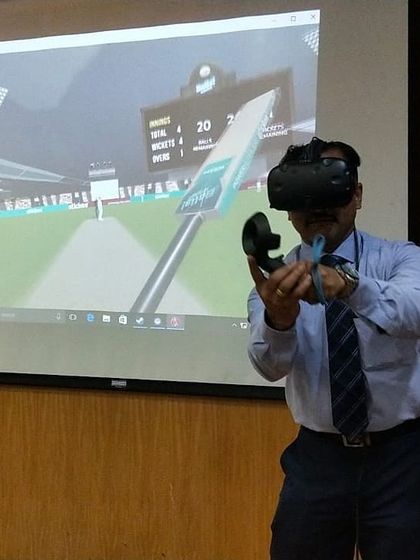 Our VR cricket setup is versatile enough to be installed anywhere, even in a corporate conference room. Here, a doctor takes a break from a meeting to try his hand at our immersive game, showcasing how we can bring fun into any professional setting.