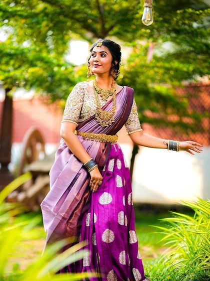 A side profile that gives a good look at the intricate hairstyle and the heavy temple jewellery.