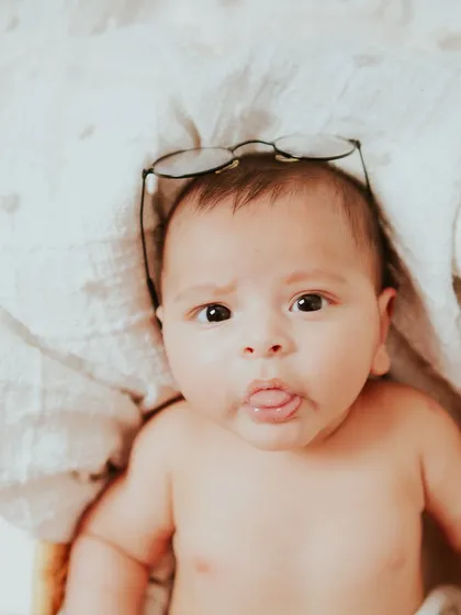A cheeky little tongue-out moment. These playful expressions make for the most memorable baby photos.