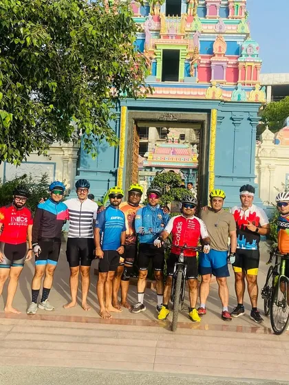 The full group outside the colorful temple. The vibrant architecture provides a beautiful backdrop for our photos.