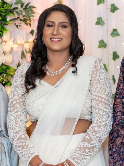 A shot from the engagement party. The bride's makeup looks flawless and elegant, even in the midst of the celebration.