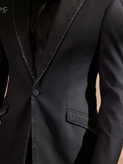 A detail shot of the glittering trim along the lapel and pocket of the jacket. It’s an example of how I use subtle details to make a piece extraordinary.