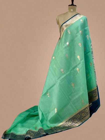 A fresh sea-green pure Kora organza saree with a dark blue traditional Banarasi border.