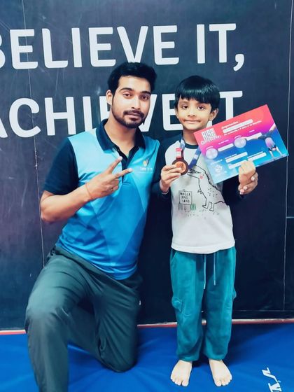 This young boy is all smiles with his new medal and certificate.