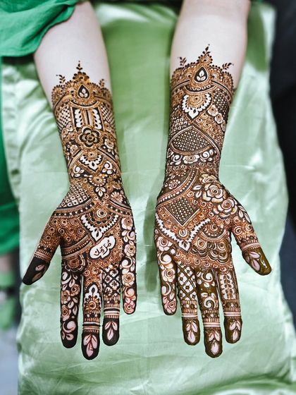 A unique bridal design incorporating the couple's initials "A" and "S" into the intricate patterns.