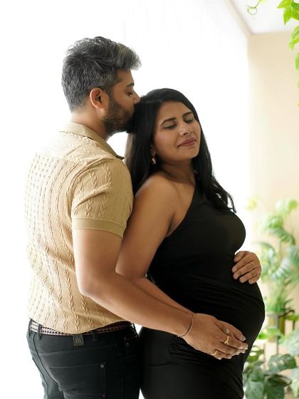 A quiet embrace from behind, showing support and love in a naturally lit studio setting.