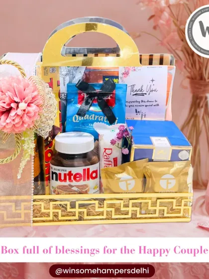 For the happy couple, I craft wedding hampers filled with blessings and indulgence. This beautiful hamper in a golden acrylic basket includes everything from Nutella and Raffaello to other premium treats, all elegantly packed.