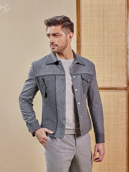 This grey shacket with unique pocket detailing offers a playful edge on a monochrome look. It's a versatile piece for smart casual occasions from travel to evening events.