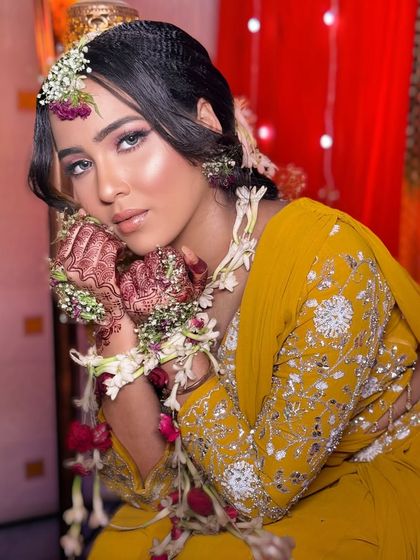Another angle of the Haldi look, showing the intricate details of the floral jewelry and henna.