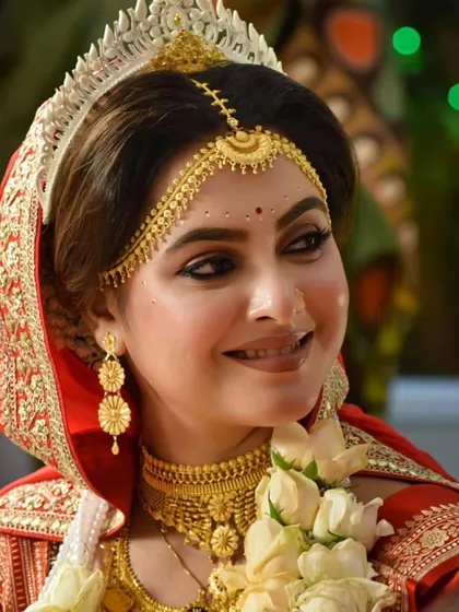 A close-up portrait of a radiant Bengali bride. Her smile says it all. I focus on capturing these happy expressions, highlighting the beautiful makeup, jewelry, and traditional mukut.