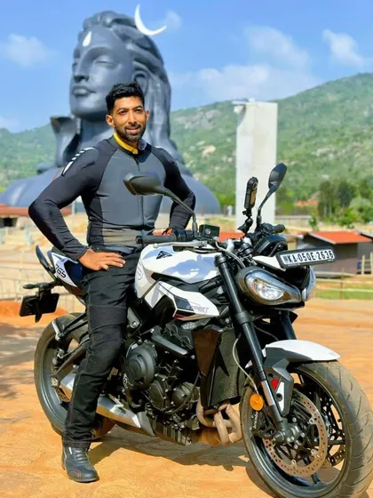 A powerful sight on one of our spiritual rides: my Triumph Street Triple parked before the Adiyogi statue. We often ride to places that offer both scenic beauty and a deep sense of peace.