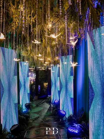 The immersive walkway for the celestial sangeet, lined with LED panels displaying moving graphics. This created a dynamic and unforgettable experience for guests as they entered the party.