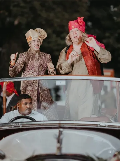 The groom's arrival in style. A vintage car adds a touch of classic elegance to the baraat, making the entrance memorable and perfect for photos.