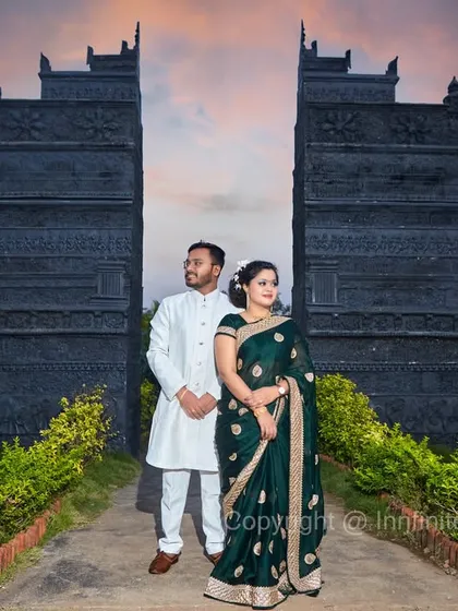A dramatic pose against a unique, temple-like structure at sunset, showcasing our ability to create powerful and memorable pre-wedding images.