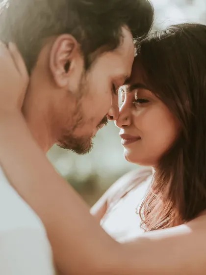 An intimate close-up portrait of a couple, their faces close together, radiating warmth and affection. This is the kind of raw, emotional moment we love to capture.