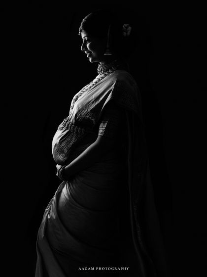 A slightly different angle of the saree silhouette, highlighting the intricate details of the fabric and jewelry.