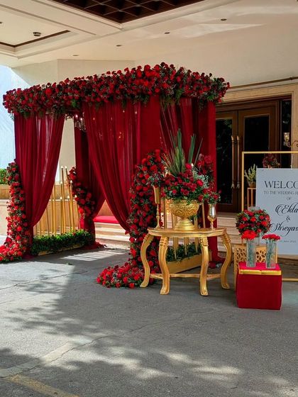 This reception entrance is a symphony in red. I used rich red drapes and dense rose arrangements to create a luxurious and passionate welcome, setting a regal tone for the evening's festivities.