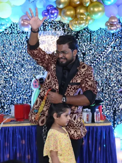 A young assistant helps me with a trick during her family's event. I make sure to create a comfortable and fun environment for all my volunteers, especially the little ones.