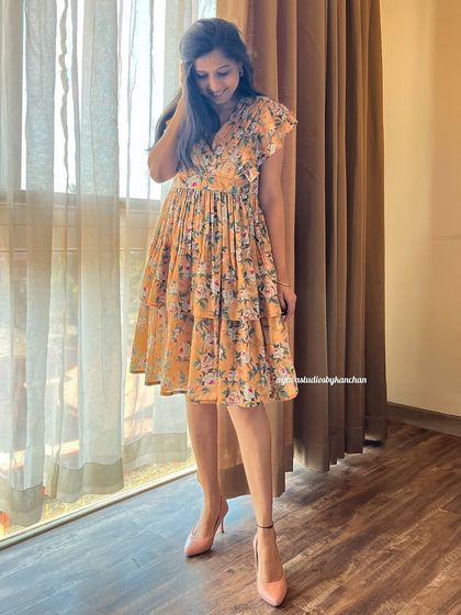 The mustard floral tiered dress, flowing with grace and charm. It's made from a printed poly-cotton and is available in sizes up to 6XL.