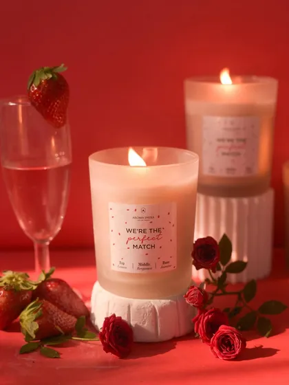 Our "We're the perfect match" candle, set against a romantic red backdrop with strawberries and roses. This candle is designed to appeal to the soul, making it a thoughtful gift for someone special.