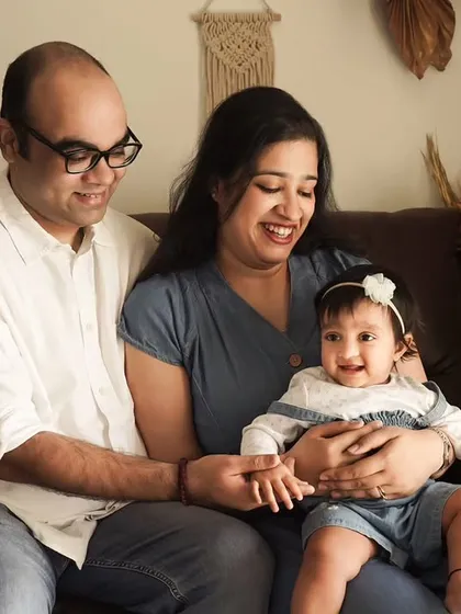 A classic family pose on the couch. Our studio is designed to feel like a home, making for relaxed and natural family portraits.