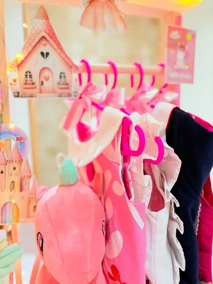 A nani's love, wrapped in magic. This close-up shows the tiny frocks from Jacadi Paris hanging in the Unicorn Wonderland hamper.