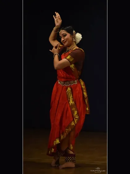 The iconic pose of Krishna playing the flute, a recurring and beloved image in the Bharatanatyam repertoire.