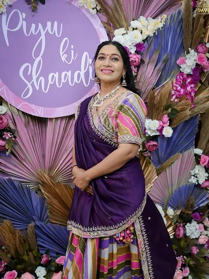 The mother of the bride, perfectly coordinated with the purple-themed decor, a testament to our attention to detail.