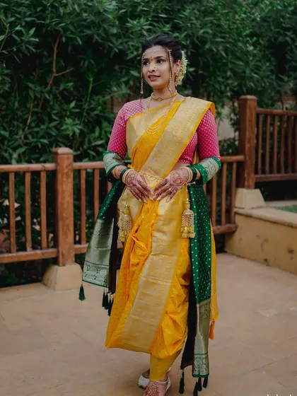 The full view of a stunning Nauvari saree. Draping this traditional nine-yard saree is an art, and the makeup was designed to match its grace and grandeur.