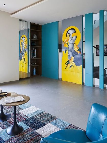 Art becomes an integral part of the architecture in this space. A bold, colorful mural is integrated into a set of rotating panels, creating a dynamic feature that is both a functional partition and a piece of statement art.