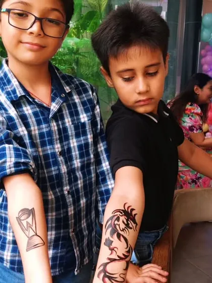 Our temporary tattoo station is always a party favorite. These two boys are proudly showing off their cool dragon and genie tattoos. It's a simple, fun addition that brings a lot of smiles.
