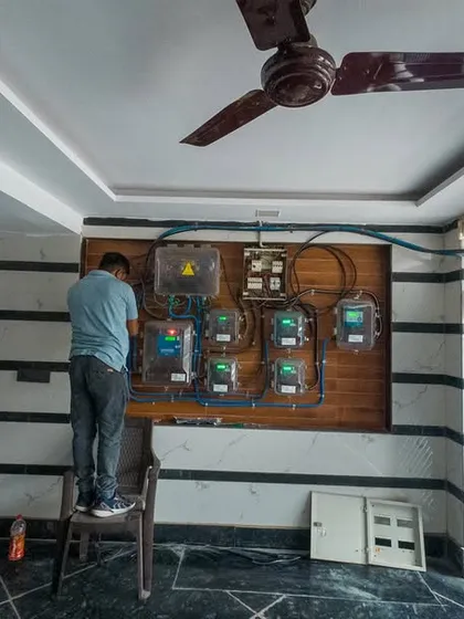 Our commitment to quality extends to every detail. Here, our technician is ensuring a neat, safe, and compliant connection of the new solar system to the home's main electrical panel. We handle all wiring and net metering work ourselves.